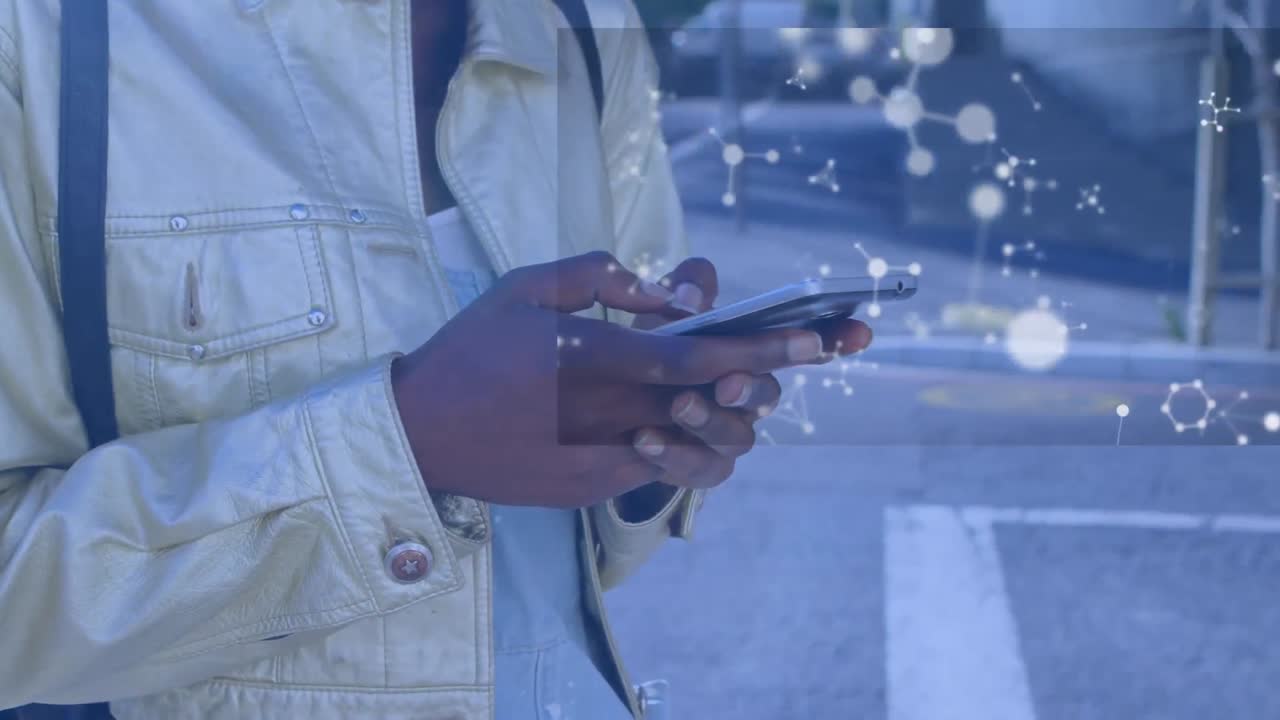 Animation of floating nucleotides over african american woman using smartphone on street