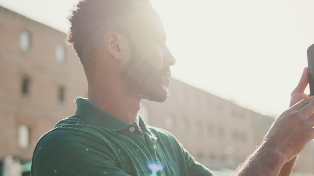 Man taking photos with his phone outdoors