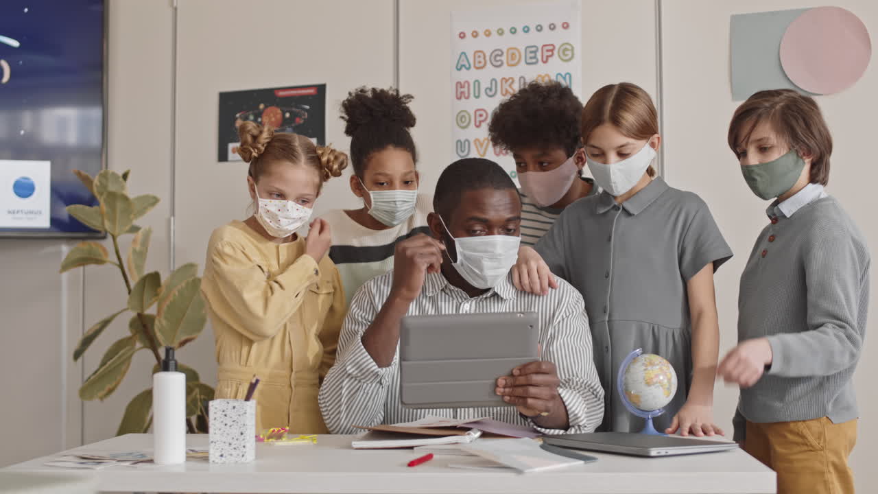 Cheerful Schoolchildren and Teacher Waving Hands to Camera