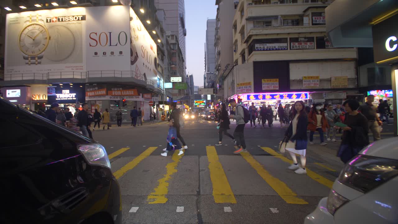 Free stock video - Tracking between traffic towards busy square