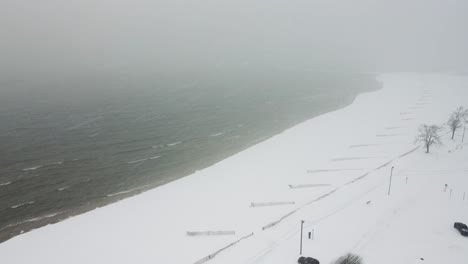 heavy snow falling thick along the eastern coast of lake michigan