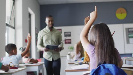 Video-of-happy-african-american-male-teacher-during-lesson-with-class-of-diverse-pupils