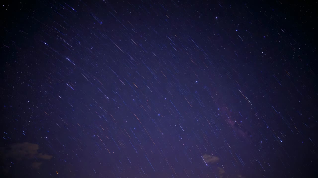 Starting exposure, camera capturing star trails forming over night sky to show rotation, with cloud
