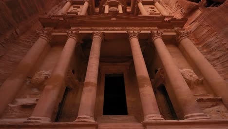 the treasury at petra, historic unesco heritage site carved into sandstone in jordan seen from below upward pan