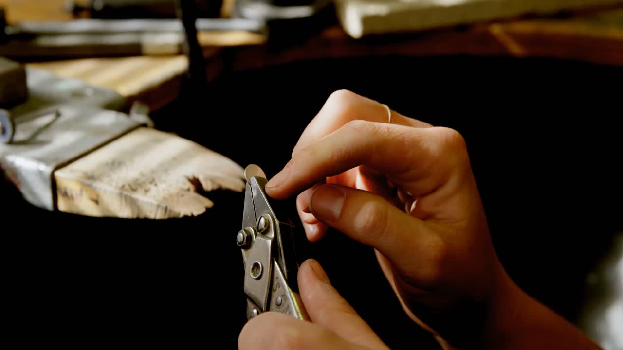 Jewelry designer making jewelry in workshop 4k