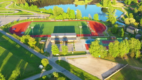 stadium and surrounding area in aerial approaching shot during golden hour