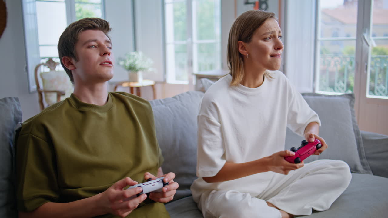 Friends playing video game enjoying online competition at apartment closeup