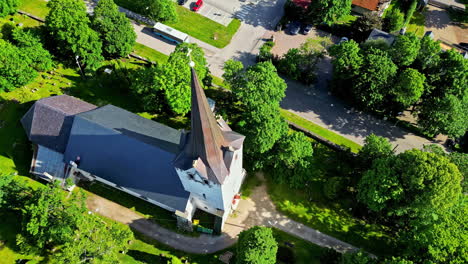 Aerial-drone-rotating-shot-over-Old-Keila-Church-Building-in-Tuula-tee,-Keila,-Harju-Maakond,-Estonia-on-a-sunny-day