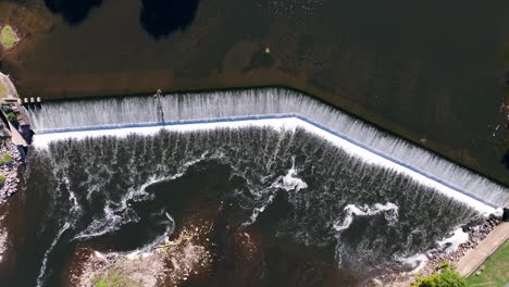 top down aerial of dam on river waterfall in usa city