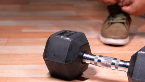 dumbbell and person getting ready for workout