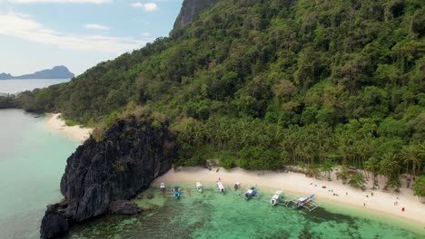 Vídeo-De-Dron-En-4k-De-Personas-Disfrutando-De-La-Playa-Papaya,-Una-Playa-Tropical-De-Arena-Blanca-En-Palawan,-Filipinas