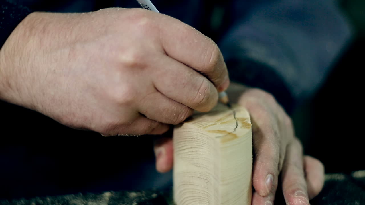 Man Uses An Electric Saw To Cut Wooden Planks. Carpenter is sawing a wooden plank with jig saw machine in carpentry workshop
