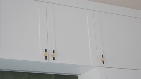 white kitchen cabinets with gold hardware