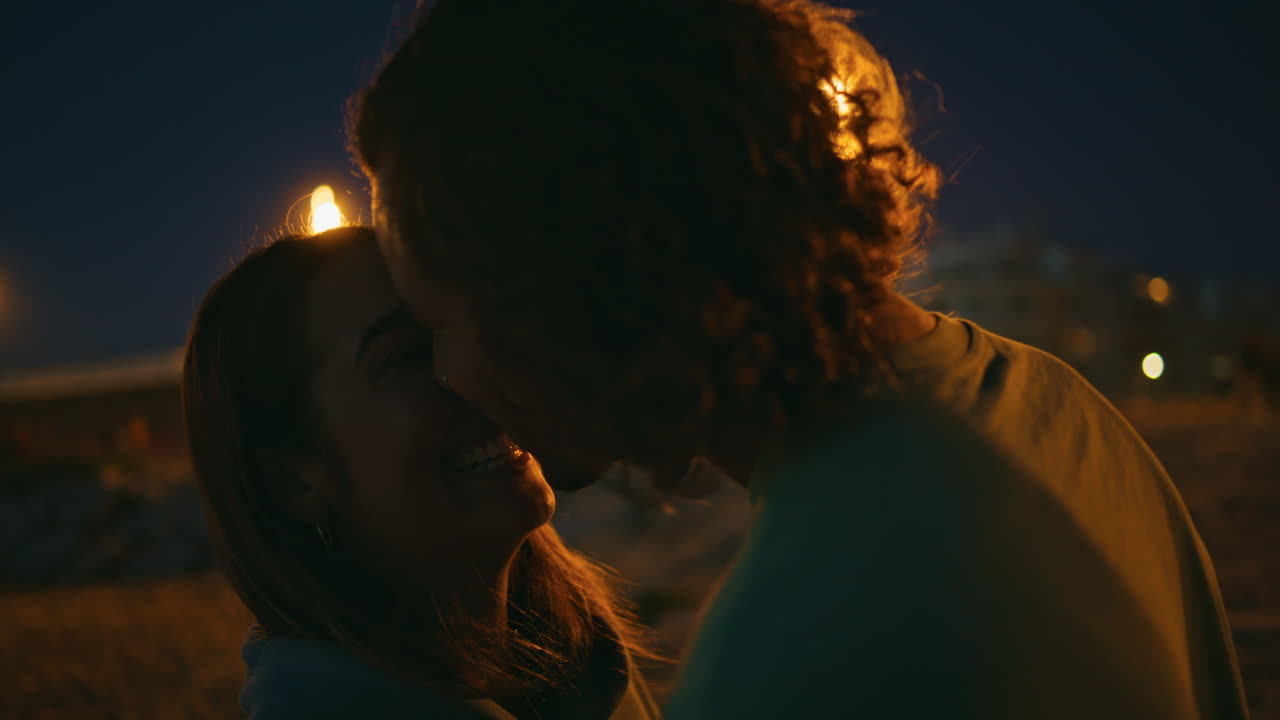 Guy touching girl nose on romantic date night close up.Man kissing girlfriend