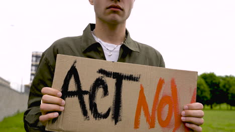 close up of a man holding a placard 2