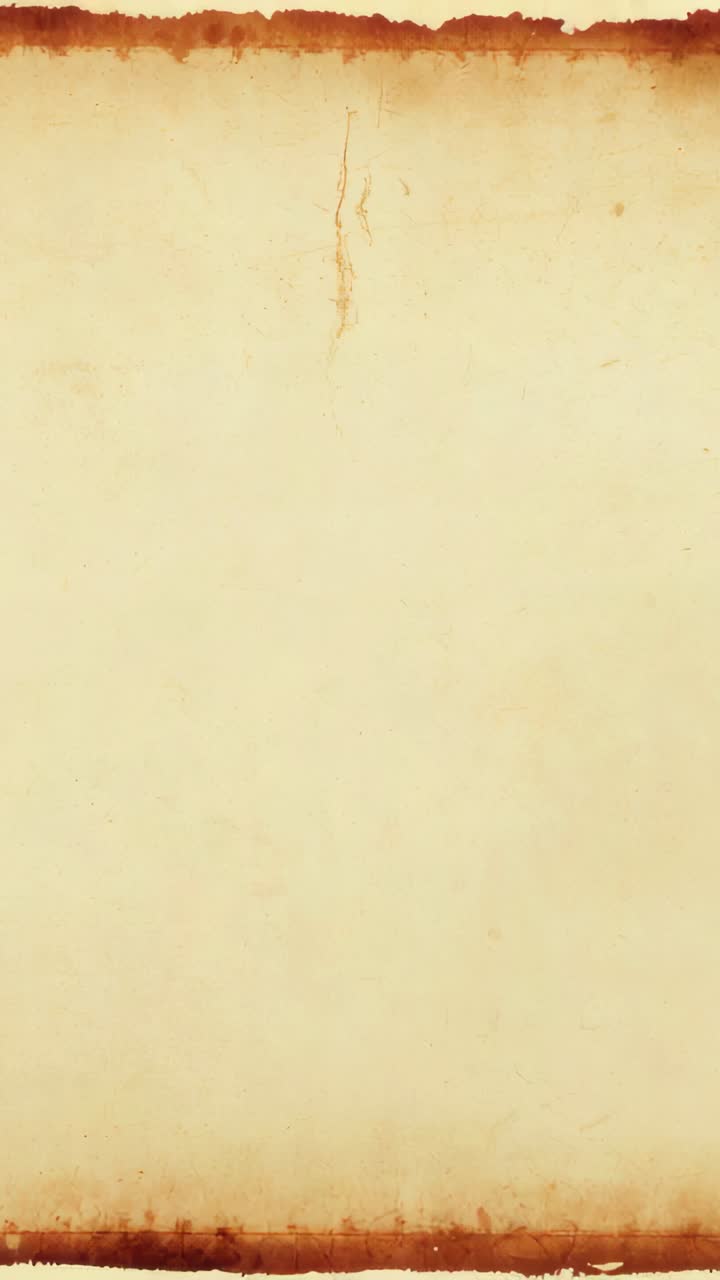 Vertical video: Showing aged parchment developing pale mark from right then fading, burnt edges