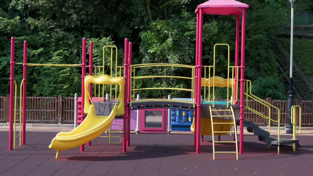 An empty slide on a children's playground is seen at a park in Hong Kong