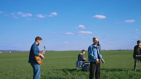 musical band on field. young musical band performing concert on nature