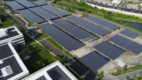 Solar-panels-installed-in-a-corporate-office-complex-parking-lot-and-solar-panels-on-the-office-complex-buildings