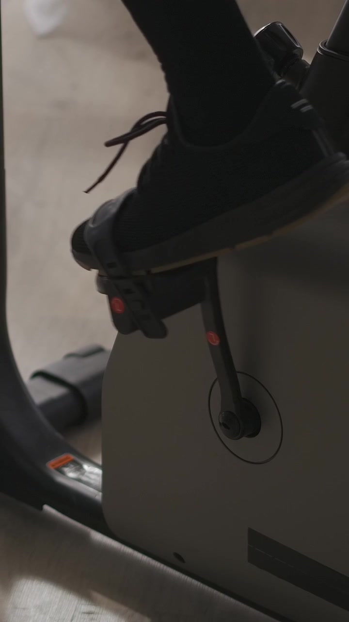 Close-up of Person's Legs Pedaling on an Exercise Bike