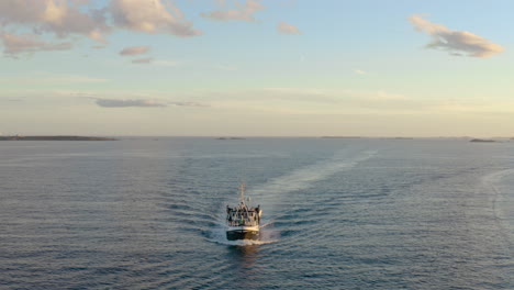 Fishing-Vessel-Cruising-At-Skagerrak-Strait-Near-Lille-Torungen-Lighthouse-At-Dusk-In-Norway