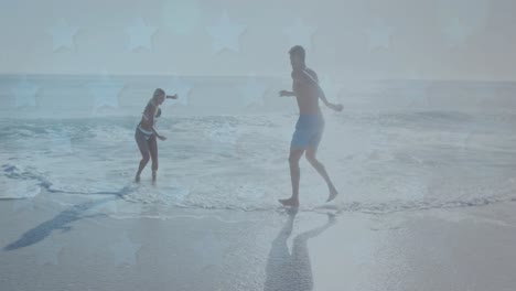 animation of stars over caucasian couple having fun on beach