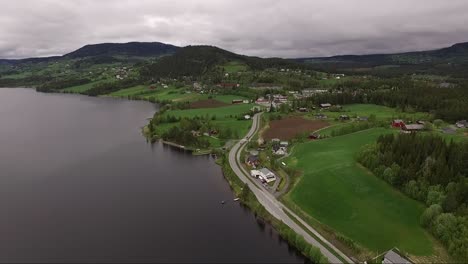spectacular panoramic views of norway on a moody day. drone flying over lake and beautiful green trees.