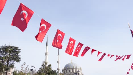 turkish flags flying in front of a mosque