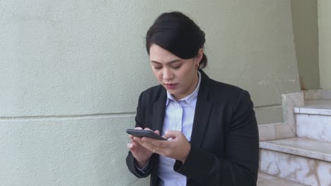 woman using mobile phone with 5g network wearing business corporate attire