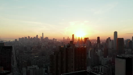 Aerial-view-of-town-development.-Skyline-with-downtown-skyscrapers-against-picturesque-sunset.-Manhattan,-New-York-City,-USA