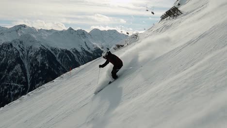 high speed downhill skiing with male ski athlete on a steep ski slope i a ski resort in austria