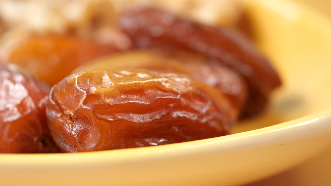 Close up of Dates in a Yellow Plate