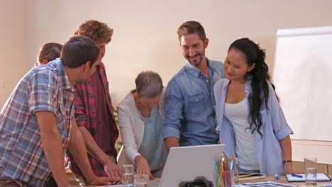 Creative-business-people-looking-at-laptop-