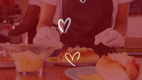 preparing food with gloves, person adding cheese over animation of hearts