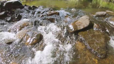 slowmotion view of water and stones in the ardennes, belgium, europe, filmed in 2