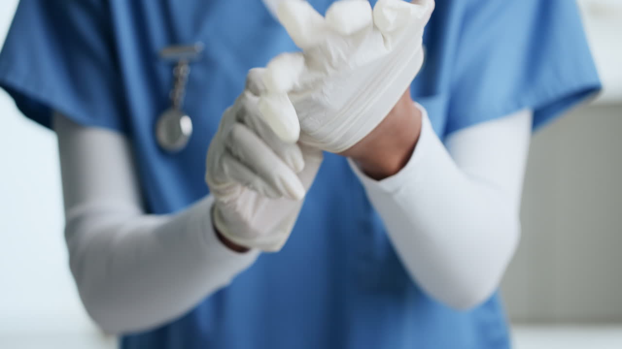 Healthcare professional putting on gloves