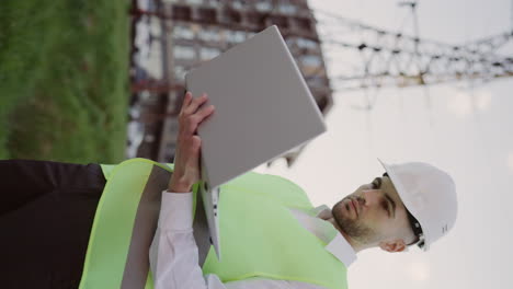 construction worker or engineer using laptop on site