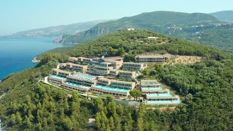 aerial orbiting shot of scenic hotel elix mar-bella located on greenery landscape in greece