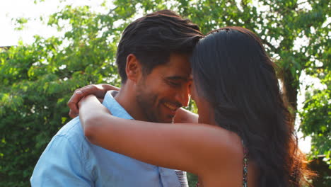 Loving-Couple-Hugging-Outdoors-In-Summer-Garden-Or-Countryside