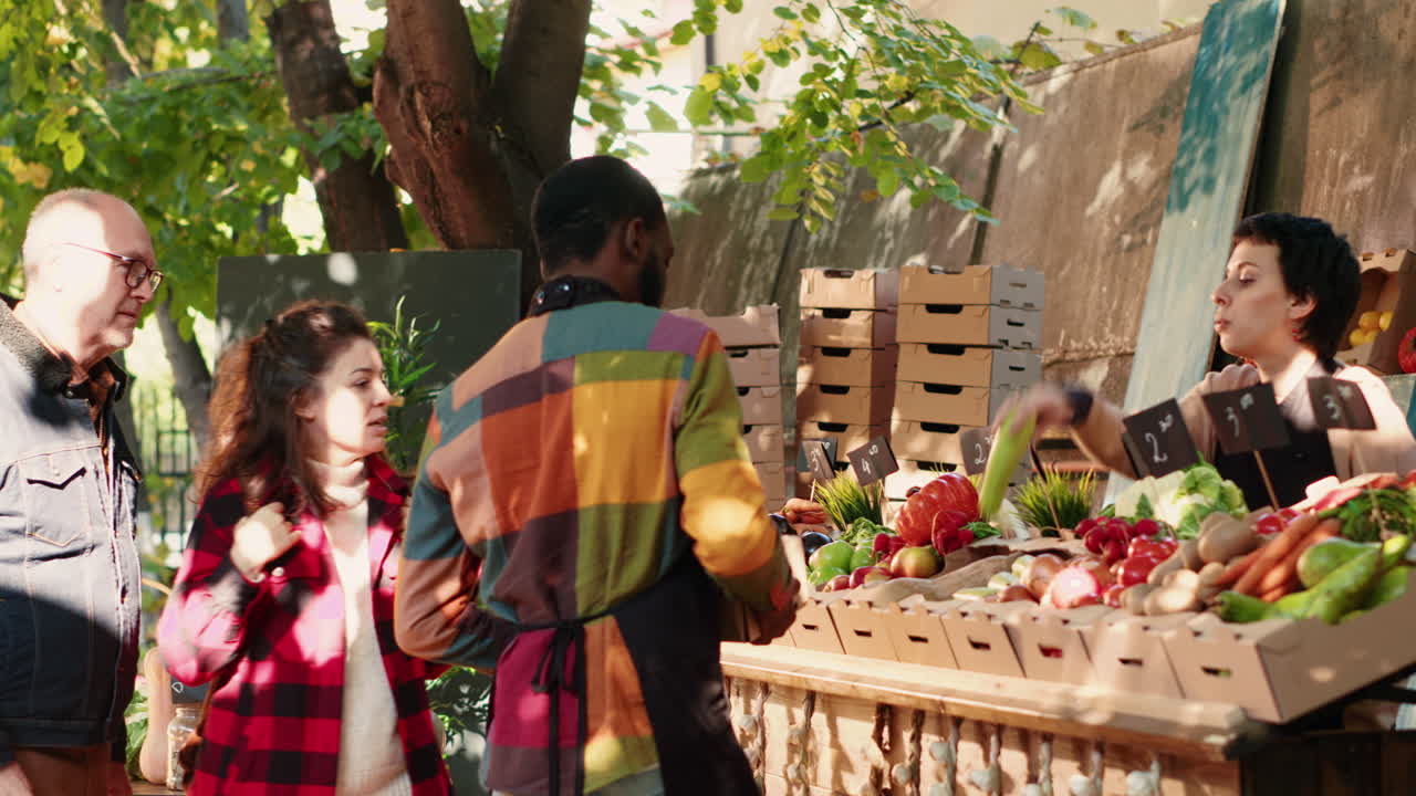 People shopping for vegetables at a farmers market
