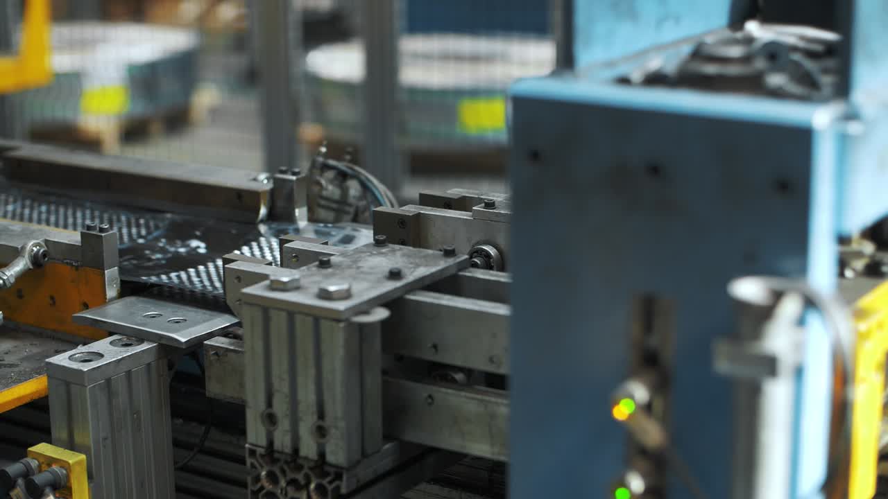 Perforated steel sheet moving on industrial machinery for washing drum at plant