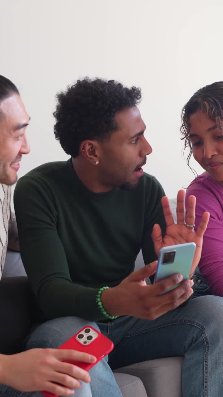 Happy Friends Sharing Content on Smartphone at Home