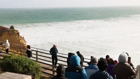 people enjoying scenic view of ocean cliffs