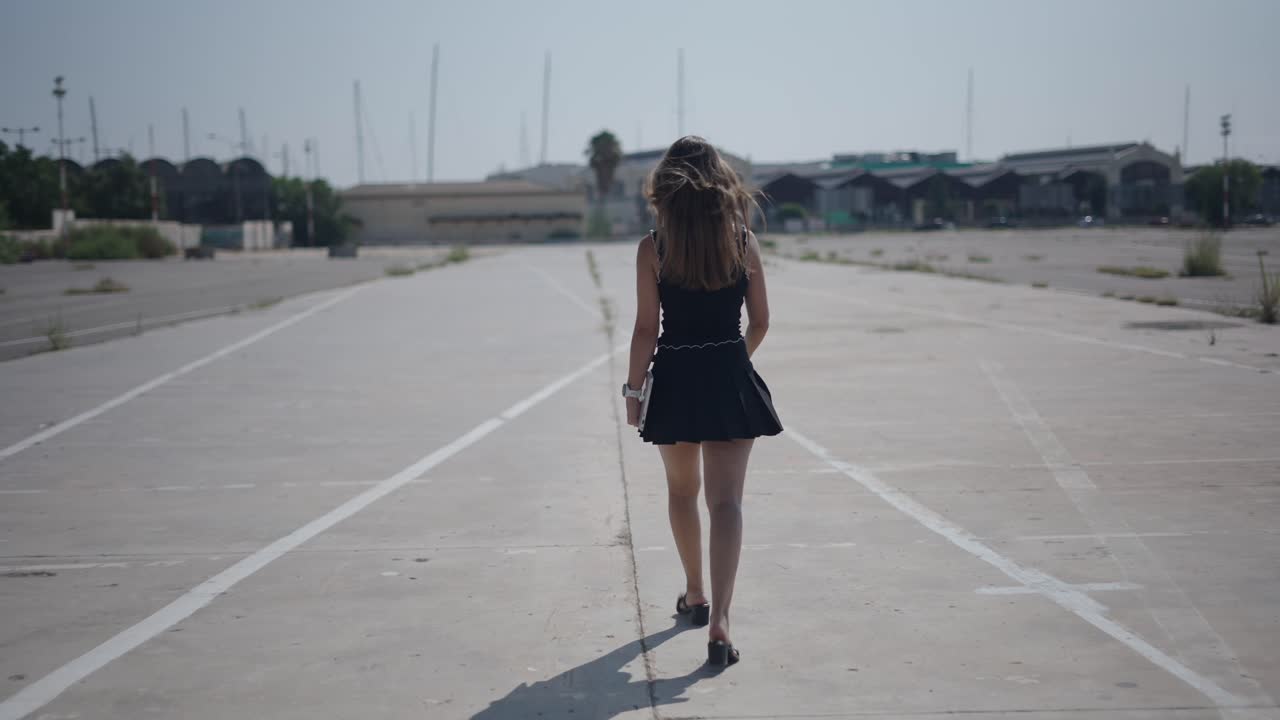 Woman Walking in Empty Parking Lot