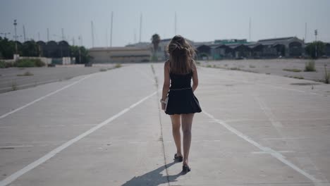 woman walking in empty parking lot