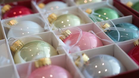 variety of shiny colored christmas tree balls stored in a box