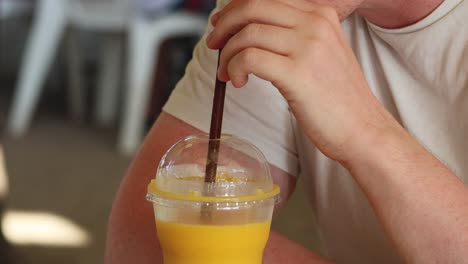 person mixing a drink with a straw