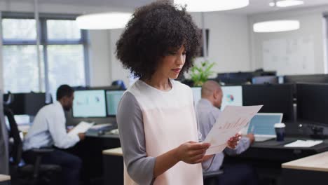 Portrait-of-happy-african-american-businesswoman-working-with-colleagues-in-office,-slow-motion