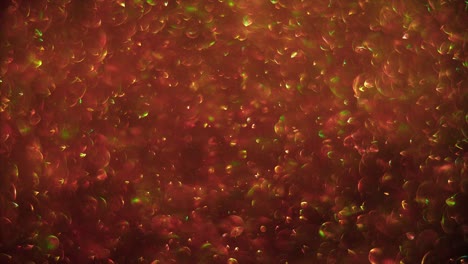 abstract glitter red-gold background with chaotical motion of bubbles. balls rotation, abstract molecular brownian motion.