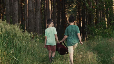 two kids holding a red backpack